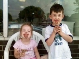 The Rocky RD Ice Cream Co. family team in front of the brick storefront
